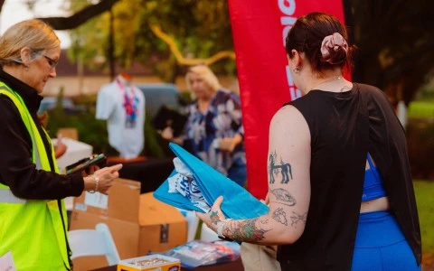 a woman holding a blue shirt