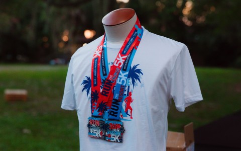 a mannequin wearing a white shirt with a red and blue lanyard