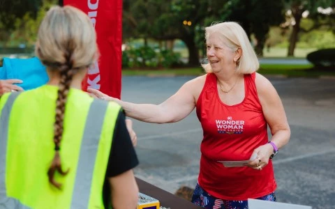 a woman shaking hands with another woman