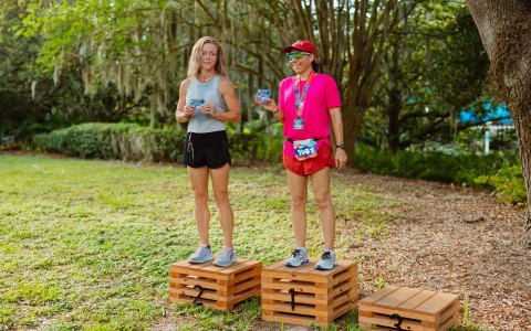 two people standing on wooden boxes
