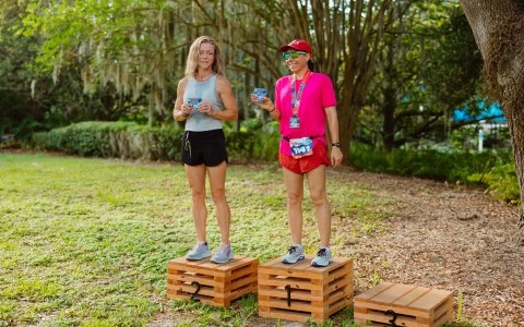 two people standing on wooden boxes
