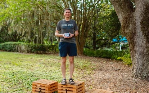 a man standing on wooden crates