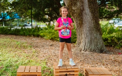 a girl standing on a wooden box