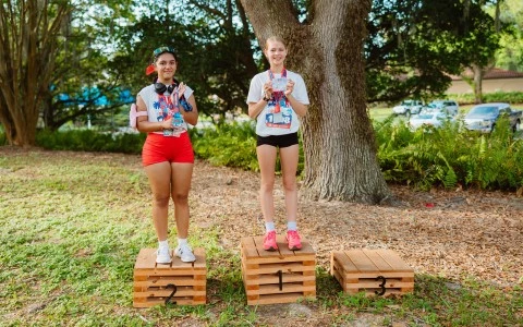 two girls standing on wooden boxes