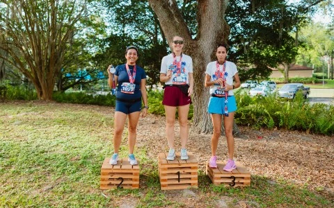 a group of women standing on wooden crates with medals