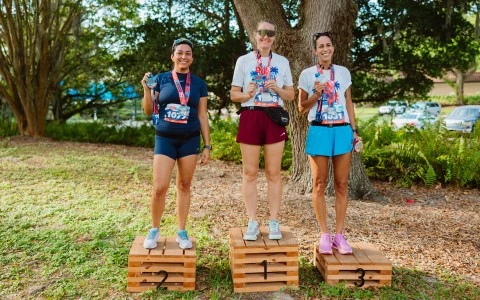 a group of women standing on wooden crates with numbers on them