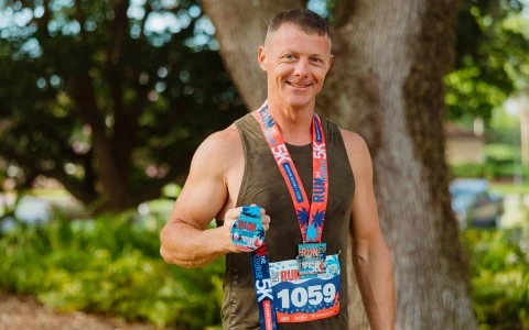 a man wearing a number and a medal