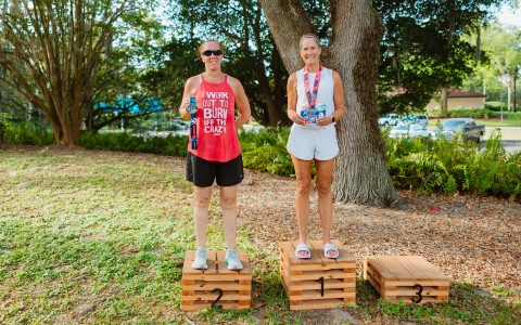 two women standing on wooden boxes