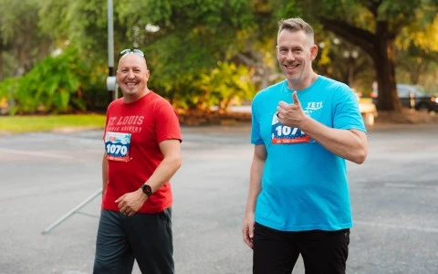 two men standing outside smiling