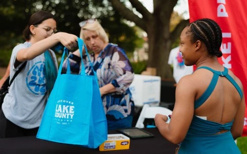 a woman holding a blue bag