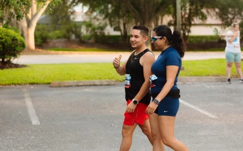 a man and woman walking in a parking lot