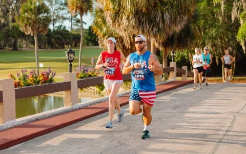 a man and woman running on a path