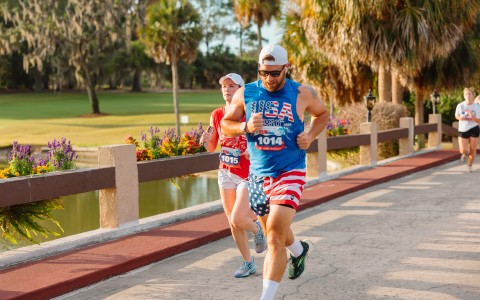 a man and woman running on a sidewalk
