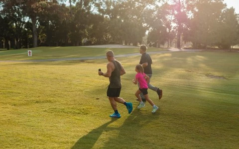 a group of people running on grass