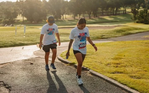 a couple of women running in a park