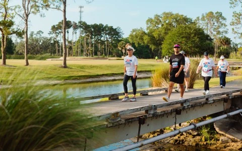 a group of people walking on a bridge