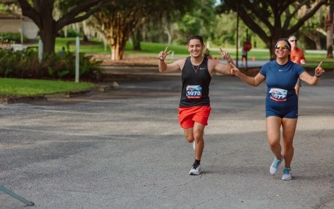 a man and woman running in a park
