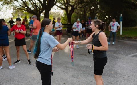 a woman holding a strap with another woman in the background