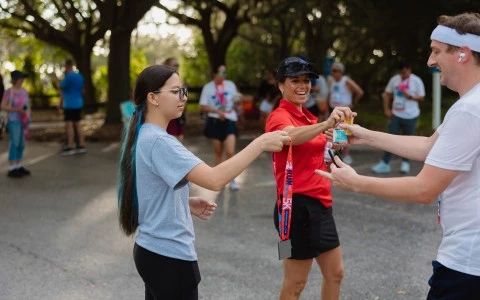 a woman receiving a medal from another woman