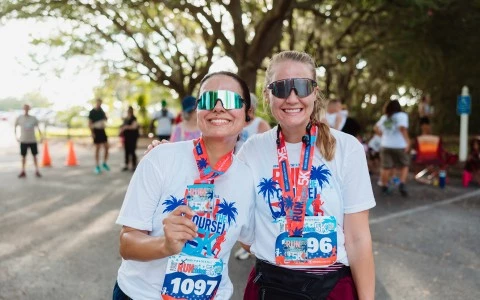 two women wearing matching shirts and matching necklaces