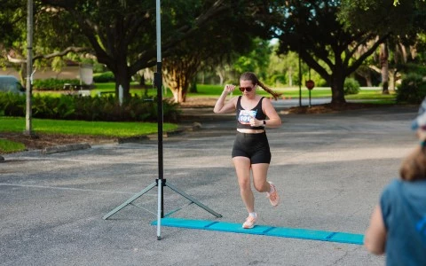 a woman running on a blue mat