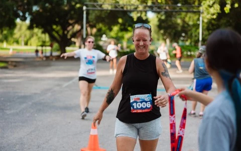 a woman running with a number on her chest