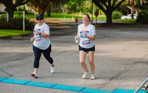 two women running on a road