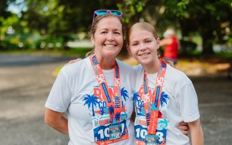 a woman and a girl wearing matching lanyards