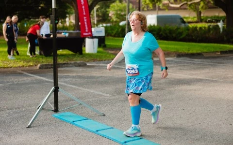 a woman running on a blue mat