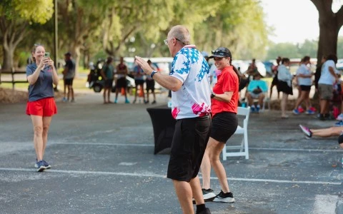 a man and woman standing in a parking lot