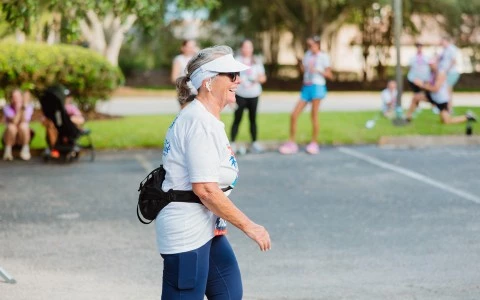 a woman wearing a white visor and a white headband