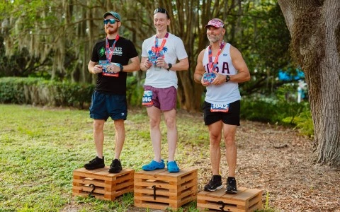a group of men standing on wooden boxes with medals