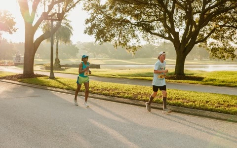 a man and woman running on a road