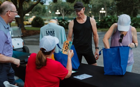 a man standing at a table with bags