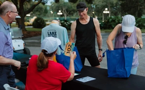 a man standing at a table with bags