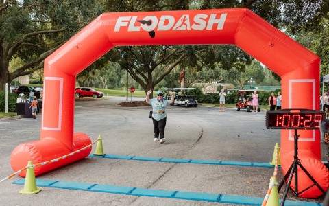 a person running through an inflatable arch