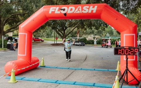 a person running through an inflatable arch