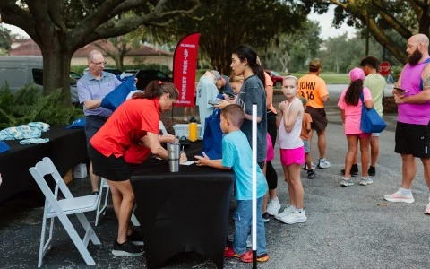 a group of people standing around a table
