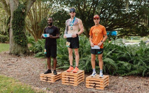 a group of men standing on wooden boxes
