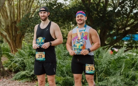 two men wearing matching shirts and running gear