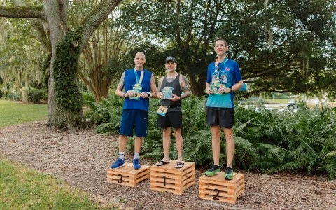 a group of men standing on wooden crates with medals