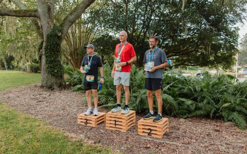 a group of men standing on wooden crates