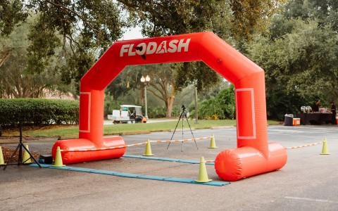 an inflatable archway with a tripod and cones