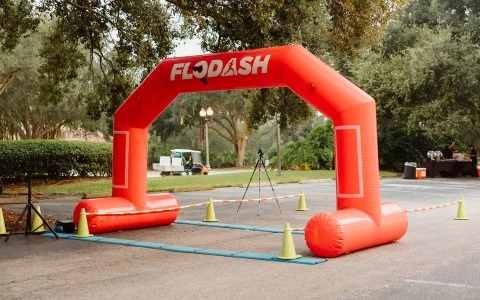 an inflatable archway with a tripod and cones