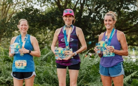 a group of women wearing medals