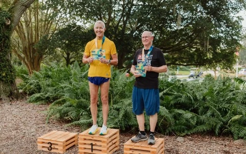 two men standing on wooden crates with medals
