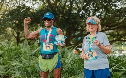 a man and woman wearing medals and holding medals