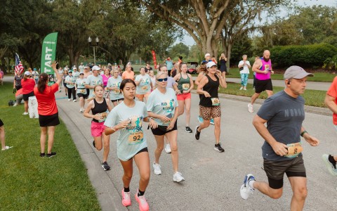 a group of people running on a road