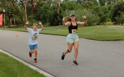 a couple of people running on a road