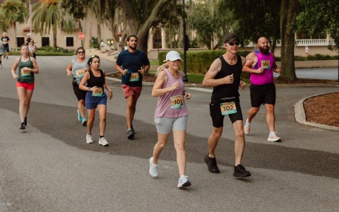 a group of people running on a road